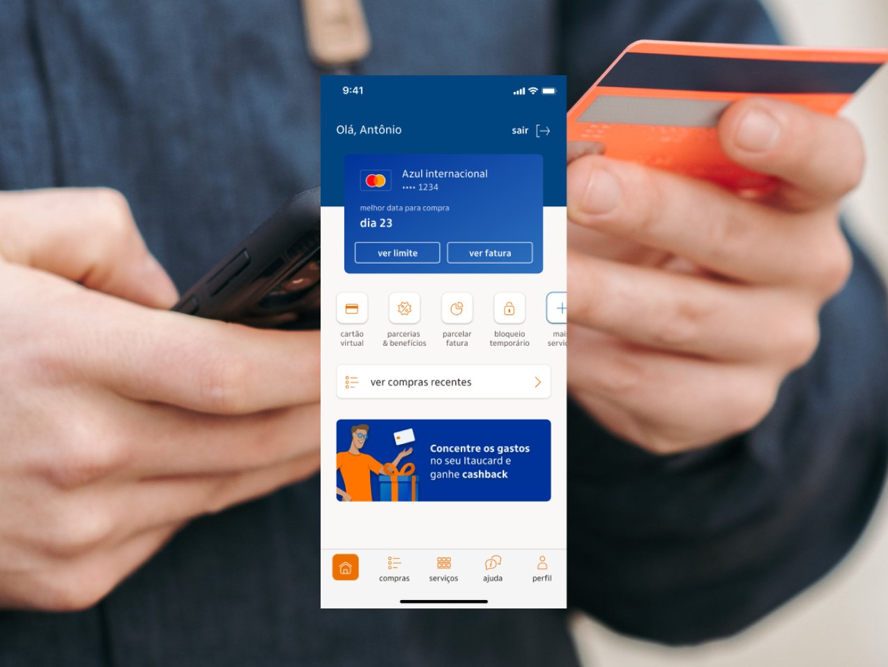Hand holding a smartphone and card showing the Credicard app home